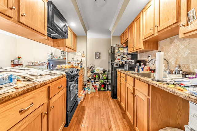 520 Vincellette St Unit C1, Bridgeport, CT 06606 - kitchen featuring black appliances, light wood finished floors, backsplash, and a sink