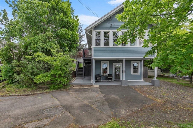 26 Shipyard Ln, Milford, CT 06460 - view of front of house with stairway, a patio, and a deck