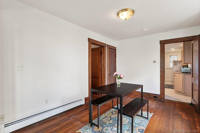 26 Shipyard Ln, Milford, CT 06460 - dining room featuring a baseboard heating unit, dark wood-type flooring, and baseboards