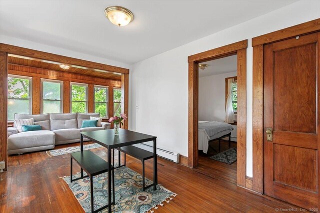 26 Shipyard Ln, Milford, CT 06460 - living room featuring baseboard heating and dark wood-style flooring