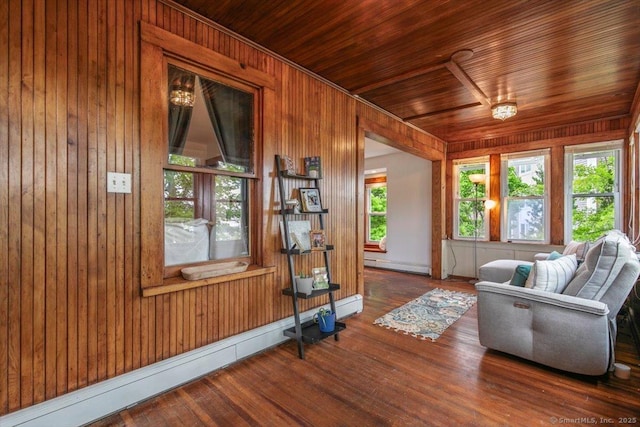 26 Shipyard Ln, Milford, CT 06460 - living room featuring baseboard heating, wood walls, wood finished floors, and wood ceiling