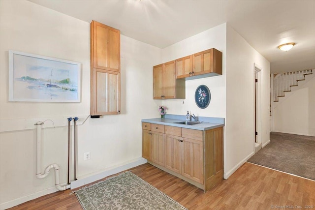 26 Shipyard Ln, Milford, CT 06460 - kitchen featuring a sink, light wood-type flooring, baseboards, and light countertops