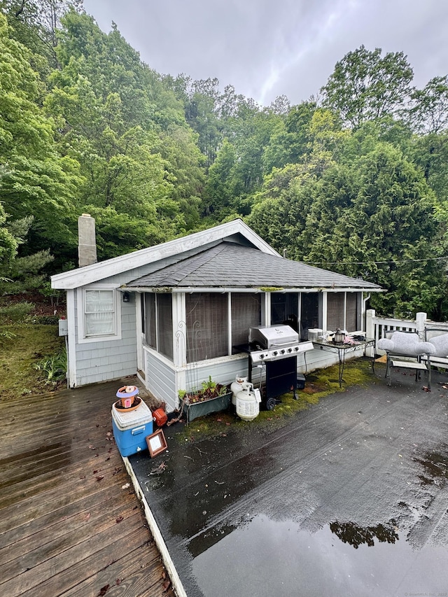 343 W Wakefield Blvd, Winchester, CT 06098 - wooden deck featuring a sunroom, a wooded view, and area for grilling