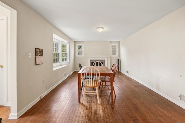 124 Jordan Ln, Wethersfield, CT 06109 - dining room with wood finished floors, baseboards, and a fireplace