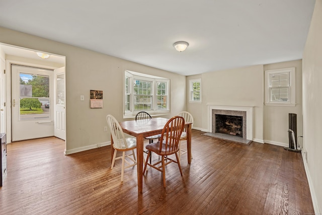 124 Jordan Ln, Wethersfield, CT 06109 - dining area with wood finished floors, a fireplace with flush hearth, and baseboards