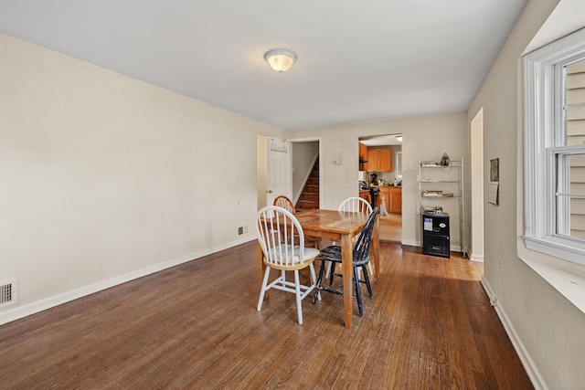 124 Jordan Ln, Wethersfield, CT 06109 - dining area with stairway, dark wood-style floors, and baseboards
