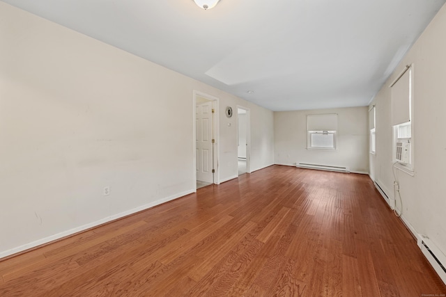 124 Jordan Ln, Wethersfield, CT 06109 - empty room featuring a baseboard heating unit, wood finished floors, and baseboards