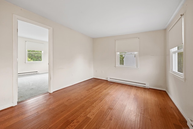 124 Jordan Ln, Wethersfield, CT 06109 - empty room featuring baseboard heating, a baseboard heating unit, wood finished floors, and baseboards