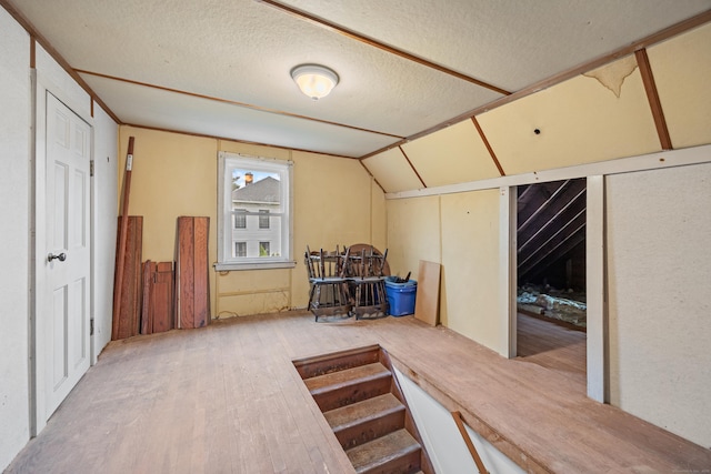 124 Jordan Ln, Wethersfield, CT 06109 - bonus room featuring lofted ceiling, wood finished floors, and a textured ceiling