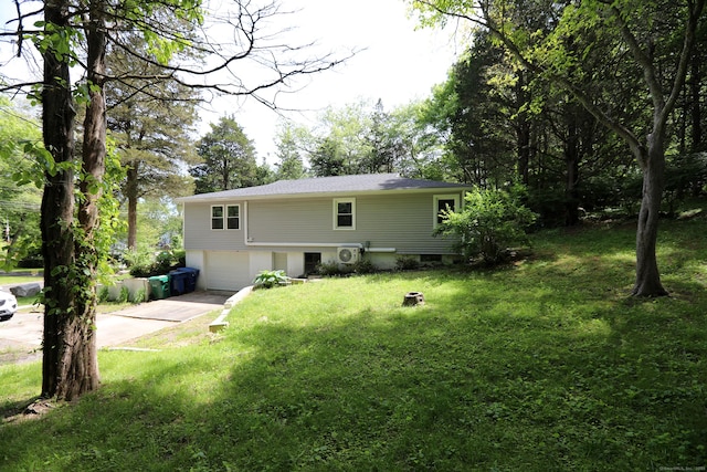 18 Totoket Rd, Waterford, CT 06375 - rear view of house with concrete driveway, an attached garage, and a lawn