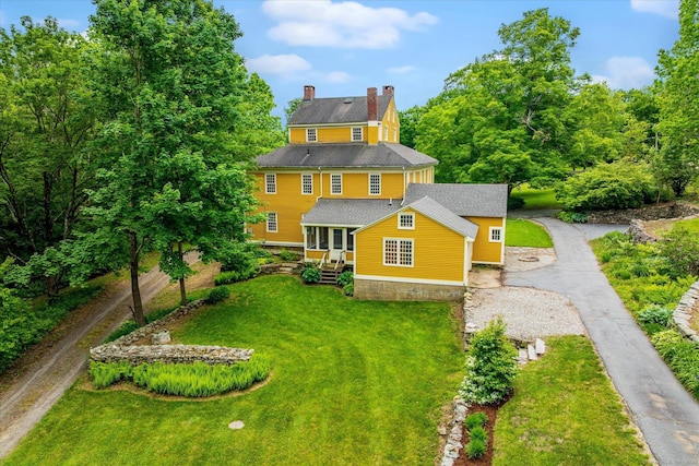 89 John Perry Rd, Eastford, CT 06242 - back of house featuring a chimney, driveway, and a lawn