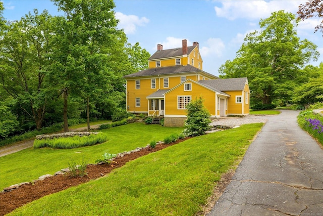 89 John Perry Rd, Eastford, CT 06242 - view of front of home featuring a front lawn, a chimney, and asphalt driveway
