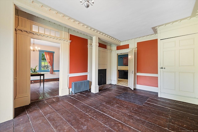 89 John Perry Rd, Eastford, CT 06242 - spare room featuring radiator, a fireplace, a chandelier, and hardwood / wood-style flooring