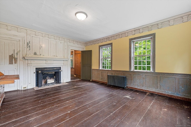89 John Perry Rd, Eastford, CT 06242 - unfurnished living room with radiator heating unit, dark wood finished floors, a fireplace with flush hearth, and a wainscoted wall