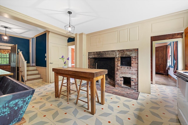 89 John Perry Rd, Eastford, CT 06242 - dining room with a fireplace, stairs, a decorative wall, a wainscoted wall, and light floors