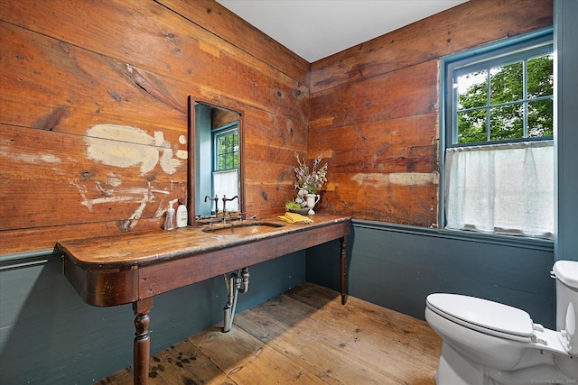 89 John Perry Rd, Eastford, CT 06242 - half bath with toilet, wooden walls, a sink, plenty of natural light, and wood finished floors