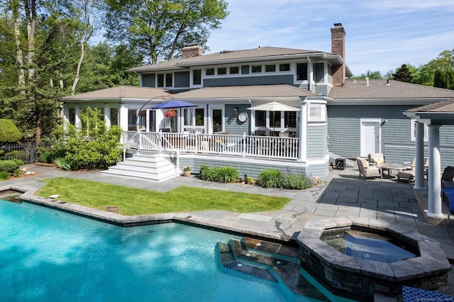 94 Southpond Rd, Glastonbury, CT 06073 - rear view of property with a chimney, a patio, a shingled roof, and a pool with connected hot tub