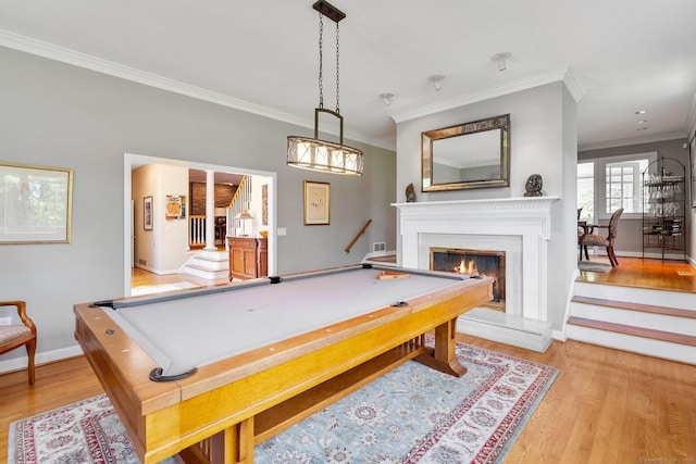 94 Southpond Rd, Glastonbury, CT 06073 - playroom with ornamental molding, wood finished floors, billiards, a warm lit fireplace, and baseboards