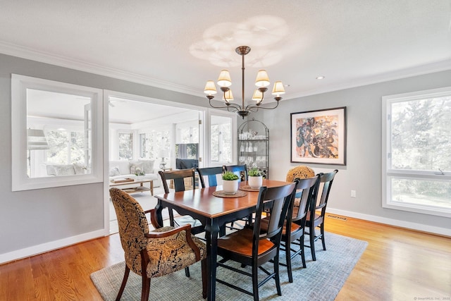 94 Southpond Rd, Glastonbury, CT 06073 - dining room featuring a chandelier, ornamental molding, baseboards, and light wood-type flooring
