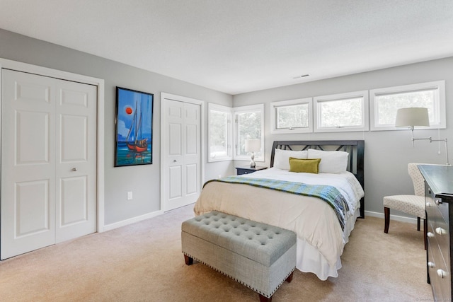 94 Southpond Rd, Glastonbury, CT 06073 - bedroom with light colored carpet, multiple windows, and baseboards