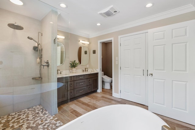 94 Southpond Rd, Glastonbury, CT 06073 - bathroom with double vanity, a walk in shower, toilet, a freestanding bath, and wood finished floors