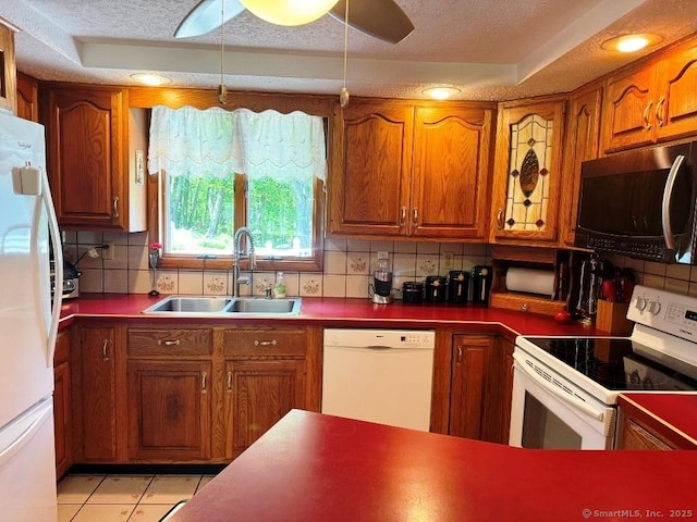 30 Cedar Ave, Wolcott, CT 06716 - kitchen with white appliances, a sink, decorative backsplash, brown cabinets, and a textured ceiling