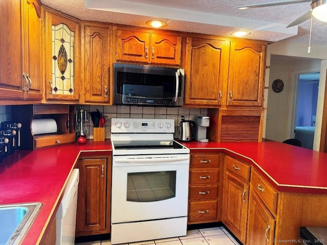 30 Cedar Ave, Wolcott, CT 06716 - kitchen with white appliances, backsplash, brown cabinets, and a textured ceiling