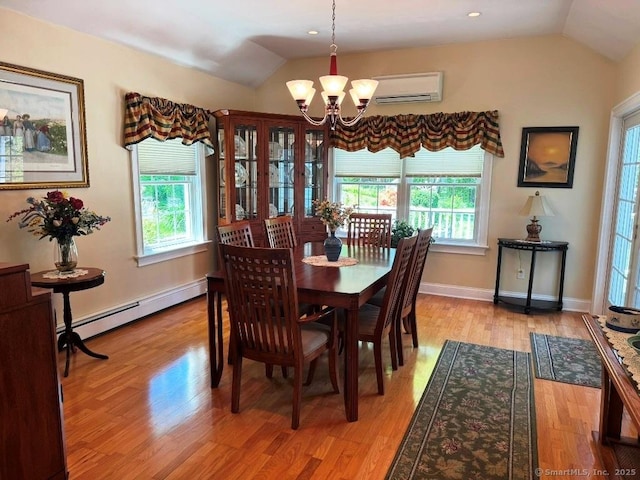 30 Cedar Ave, Wolcott, CT 06716 - dining area featuring vaulted ceiling, a wall mounted air conditioner, a chandelier, healthy amount of natural light, and light wood-style flooring