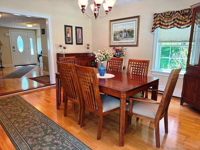 30 Cedar Ave, Wolcott, CT 06716 - dining room with a chandelier, healthy amount of natural light, light wood-style flooring, and baseboards
