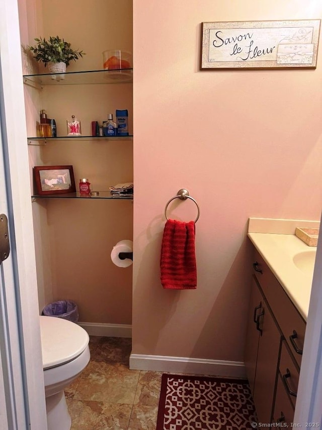 30 Cedar Ave, Wolcott, CT 06716 - half bathroom featuring vanity, toilet, and baseboards