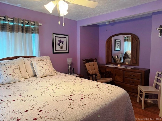 30 Cedar Ave, Wolcott, CT 06716 - bedroom with wood finished floors, arched walkways, ceiling fan, and a textured ceiling