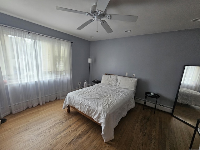 58 Waverly Pl, Bridgeport, CT 06610 - bedroom with a baseboard heating unit, wood finished floors, ceiling fan, and baseboards