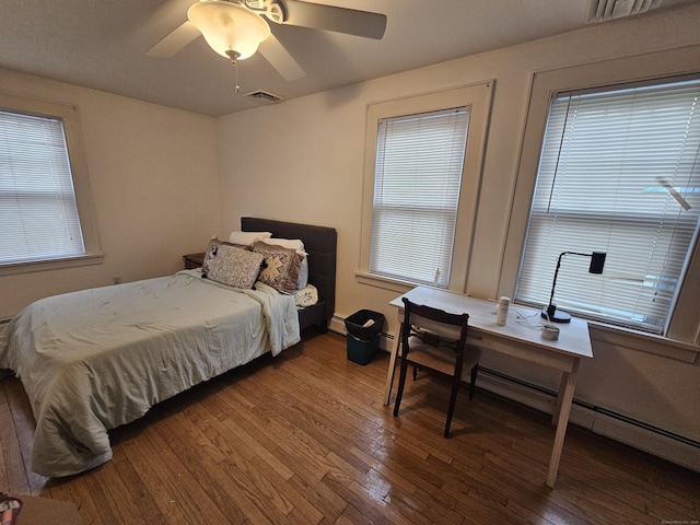 58 Waverly Pl, Bridgeport, CT 06610 - bedroom with hardwood / wood-style floors, multiple windows, an office area, and a baseboard heating unit