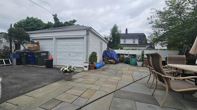 58 Waverly Pl, Bridgeport, CT 06610 - view of patio / terrace with an outbuilding, outdoor dining space, and a detached garage