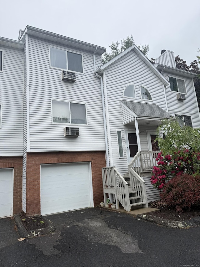 925 Oronoke Rd Unit 12G, Waterbury, CT 06708 - view of front of house featuring an attached garage, brick siding, and asphalt driveway