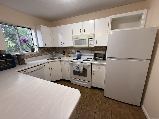 925 Oronoke Rd Unit 12G, Waterbury, CT 06708 - kitchen featuring white appliances, light countertops, a sink, white cabinets, and decorative backsplash