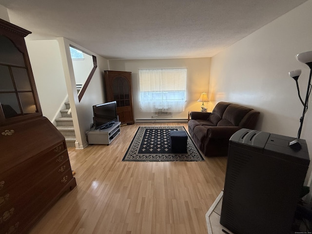 925 Oronoke Rd Unit 12G, Waterbury, CT 06708 - living area featuring a baseboard heating unit, light wood-type flooring, and stairway