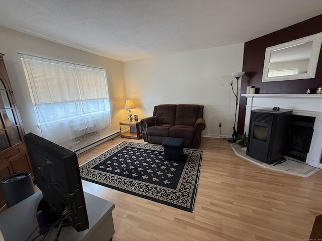 925 Oronoke Rd Unit 12G, Waterbury, CT 06708 - living room featuring baseboard heating, light wood finished floors, and a textured ceiling