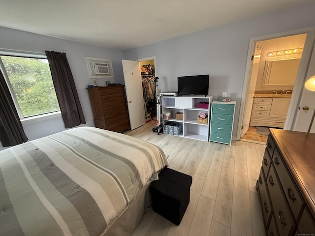 925 Oronoke Rd Unit 12G, Waterbury, CT 06708 - bedroom with light wood finished floors, a walk in closet, ensuite bathroom, a closet, and a sink