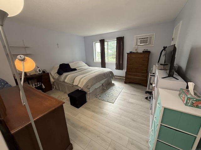 925 Oronoke Rd Unit 12G, Waterbury, CT 06708 - bedroom featuring light wood-style floors, a wall unit AC, and a baseboard heating unit