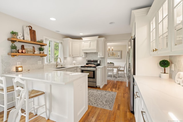 6 Lee Cir, Kent, CT 06757 - kitchen with stainless steel appliances, a sink, a peninsula, tasteful backsplash, and recessed lighting
