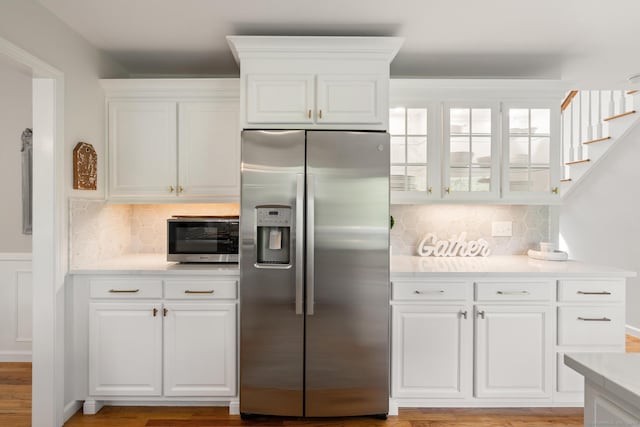 6 Lee Cir, Kent, CT 06757 - kitchen with appliances with stainless steel finishes, decorative backsplash, white cabinetry, and light countertops