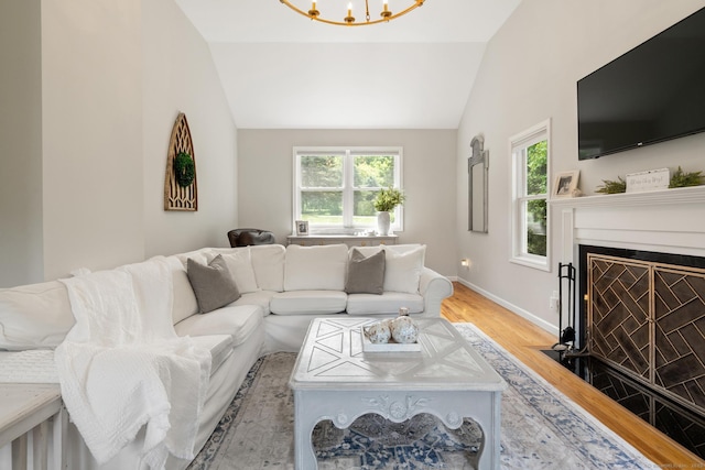 6 Lee Cir, Kent, CT 06757 - living area featuring vaulted ceiling, light wood finished floors, healthy amount of natural light, baseboards, and a fireplace with flush hearth