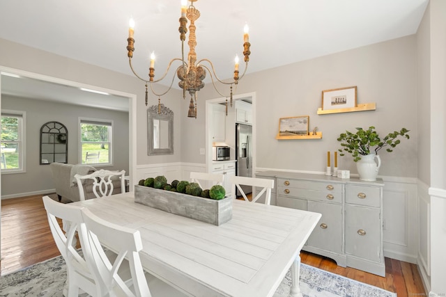6 Lee Cir, Kent, CT 06757 - dining space featuring a chandelier, a wainscoted wall, light wood-style floors, and a decorative wall