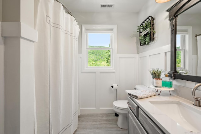 6 Lee Cir, Kent, CT 06757 - full bathroom featuring a decorative wall, toilet, vanity, wood finished floors, and a wainscoted wall