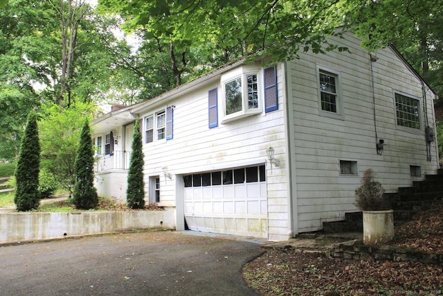 73 Devils Garden Rd, Norwalk, CT 06854 - view of front of property featuring a garage and asphalt driveway