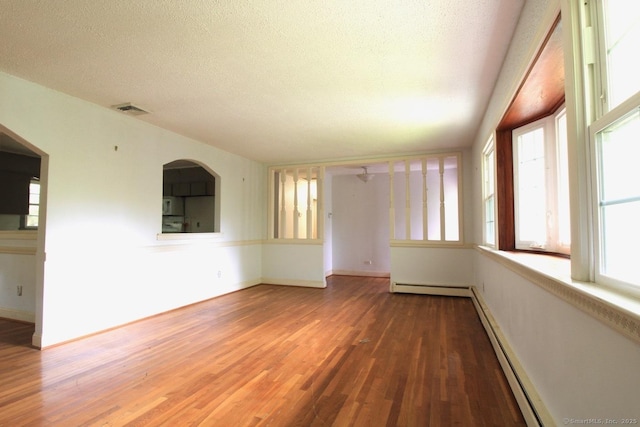 73 Devils Garden Rd, Norwalk, CT 06854 - spare room featuring wood finished floors, a textured ceiling, a baseboard heating unit, a baseboard radiator, and baseboards