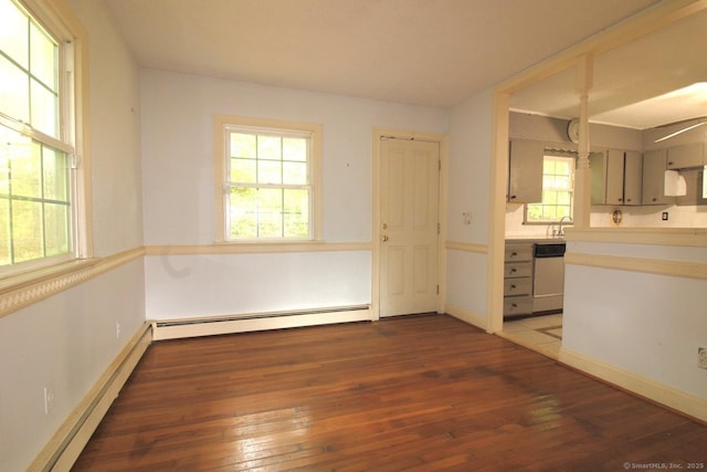 73 Devils Garden Rd, Norwalk, CT 06854 - spare room featuring hardwood / wood-style floors, healthy amount of natural light, and a baseboard heating unit