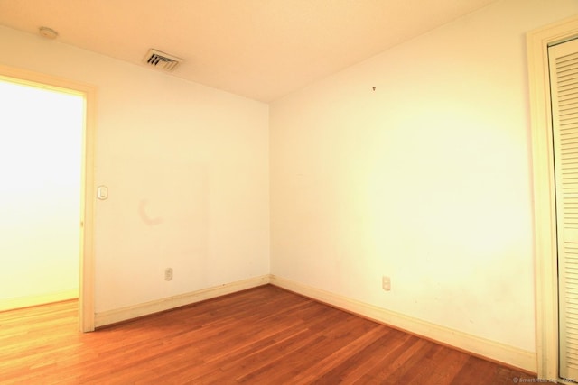 73 Devils Garden Rd, Norwalk, CT 06854 - unfurnished room with wood finished floors, baseboards, and a smoke detector