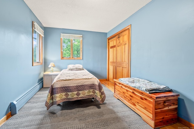 223 Beach Rd, Wolcott, CT 06716 - bedroom with a baseboard heating unit and a textured ceiling